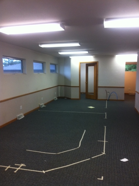 empty room in Schofield office with tape on the floor denoting furniture placement